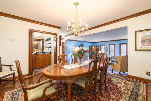 dining area with wood-type flooring, a notable chandelier, and crown molding