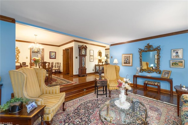 living room featuring wood-type flooring, ornamental molding, and a chandelier