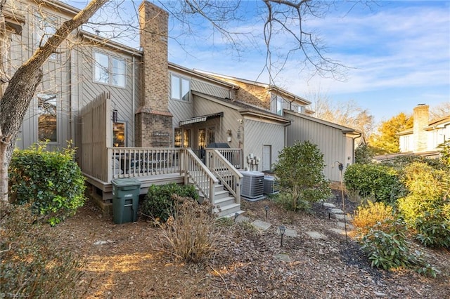 back of house featuring a wooden deck and central AC unit