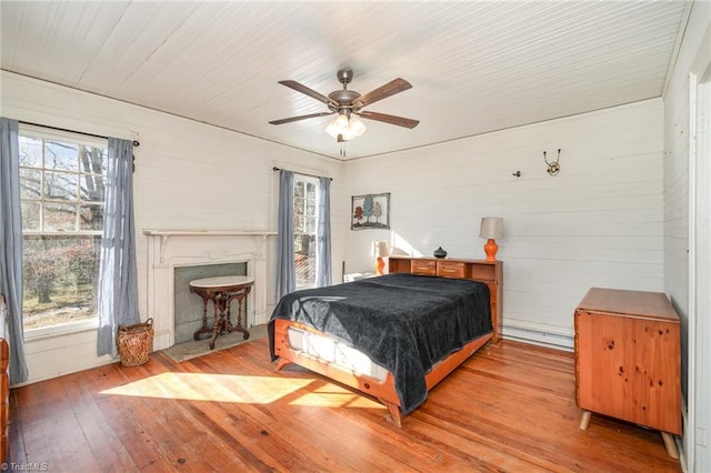 bedroom with ceiling fan and hardwood / wood-style floors