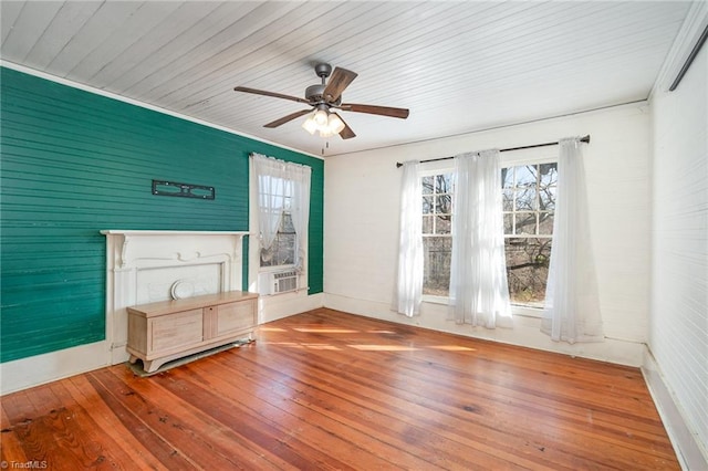 unfurnished living room featuring a wealth of natural light, hardwood / wood-style floors, and a ceiling fan