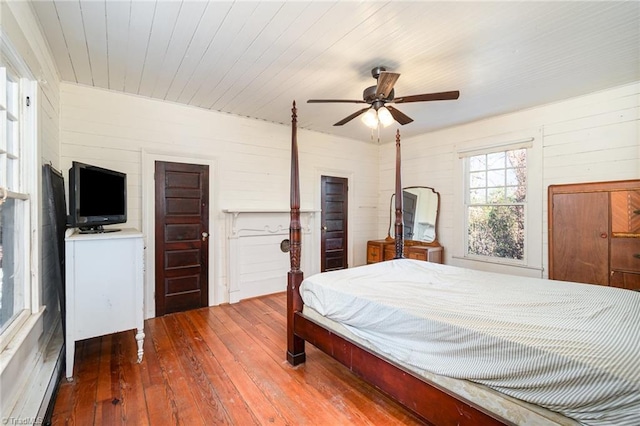 bedroom with wood ceiling, a ceiling fan, and wood-type flooring