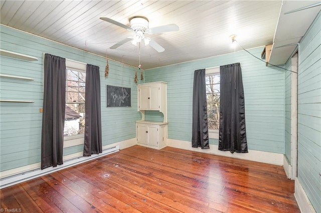 empty room featuring a ceiling fan and wood-type flooring