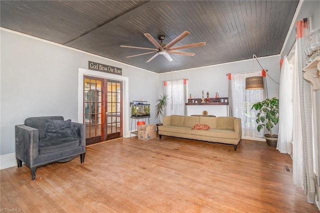 living room featuring a wealth of natural light, french doors, wood ceiling, and wood finished floors