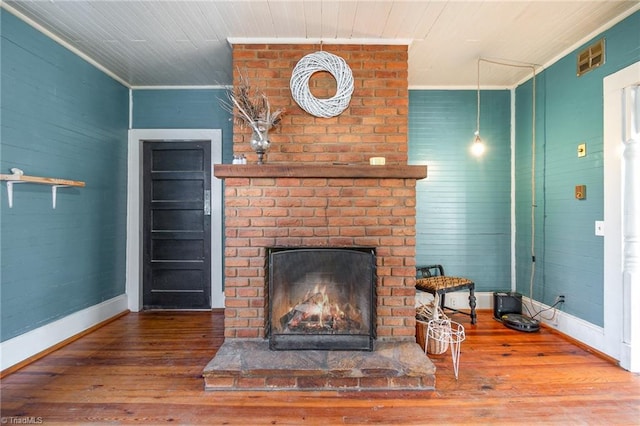 living room with a fireplace, wood finished floors, and baseboards