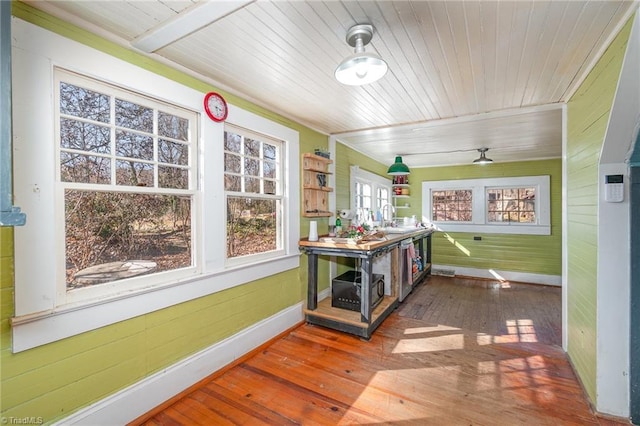 sunroom with wood ceiling and a sink