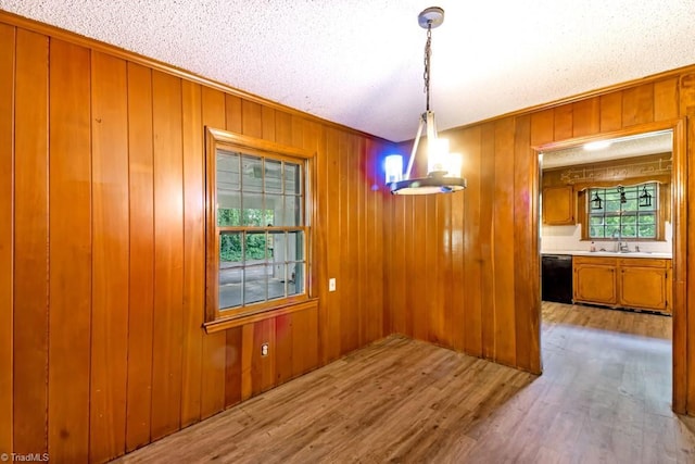 1281 Woodbrook Dr, Kernersville, NC 27284 - unfurnished dining area featuring a sink, wood finished floors, crown molding, and wood walls