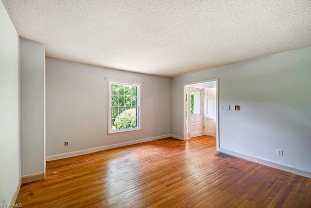 1281 Woodbrook Dr, Kernersville, NC 27284 - spare room featuring wood finished floors, a textured ceiling, and baseboards