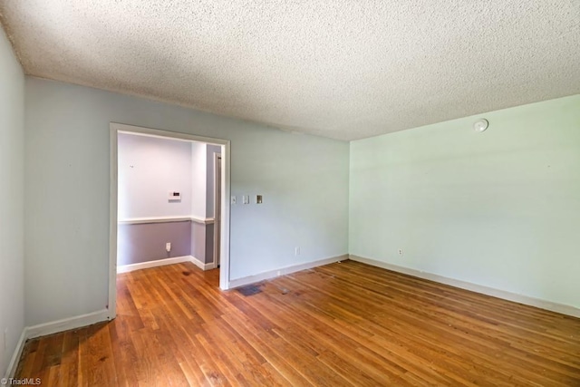 1281 Woodbrook Dr, Kernersville, NC 27284 - unfurnished room with a textured ceiling, wood finished floors, and baseboards