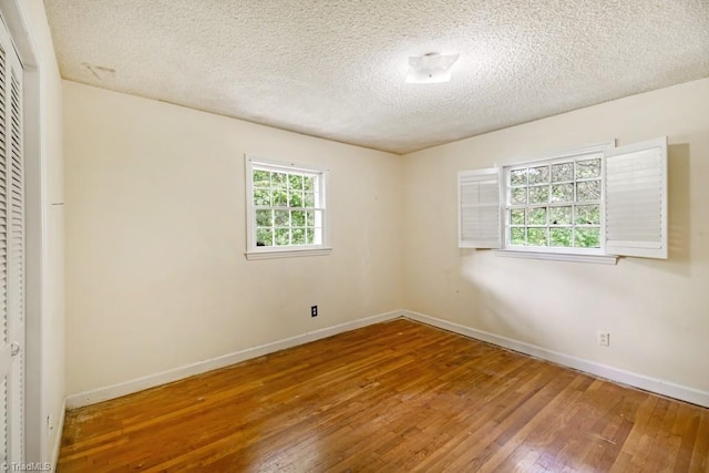 1281 Woodbrook Dr, Kernersville, NC 27284 - spare room with wood-type flooring, a textured ceiling, and baseboards
