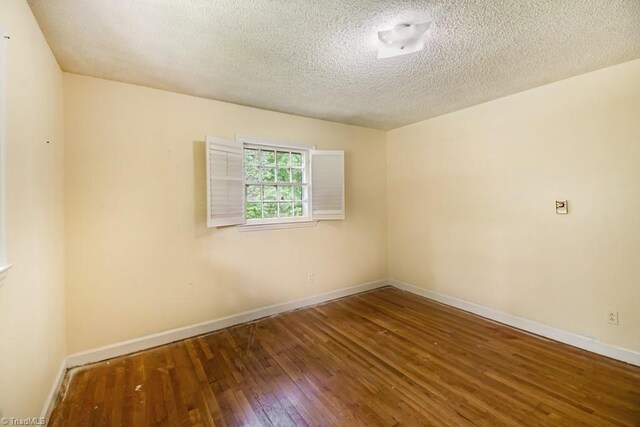 1281 Woodbrook Dr, Kernersville, NC 27284 - unfurnished room with hardwood / wood-style floors, baseboards, and a textured ceiling