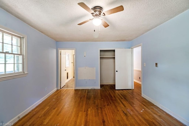 1281 Woodbrook Dr, Kernersville, NC 27284 - unfurnished bedroom with a textured ceiling, wood finished floors, a closet, and baseboards