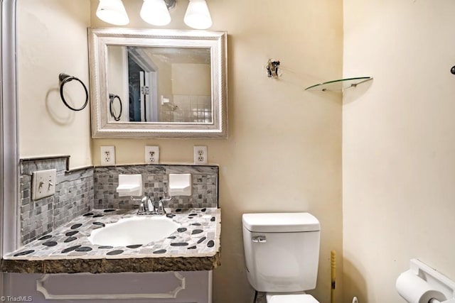 1281 Woodbrook Dr, Kernersville, NC 27284 - bathroom featuring toilet, vanity, and decorative backsplash