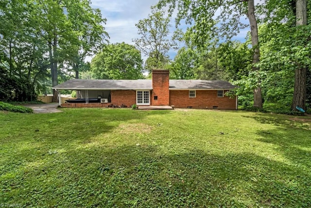 1281 Woodbrook Dr, Kernersville, NC 27284 - rear view of house featuring a jacuzzi, crawl space, a chimney, a patio, and a lawn