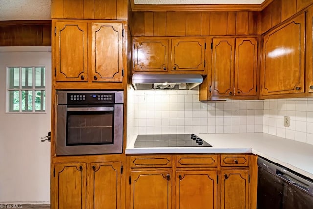 1281 Woodbrook Dr, Kernersville, NC 27284 - kitchen featuring black appliances, under cabinet range hood, backsplash, light countertops, and brown cabinetry