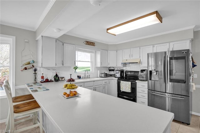 kitchen with black / electric stove, a wealth of natural light, kitchen peninsula, and stainless steel fridge with ice dispenser