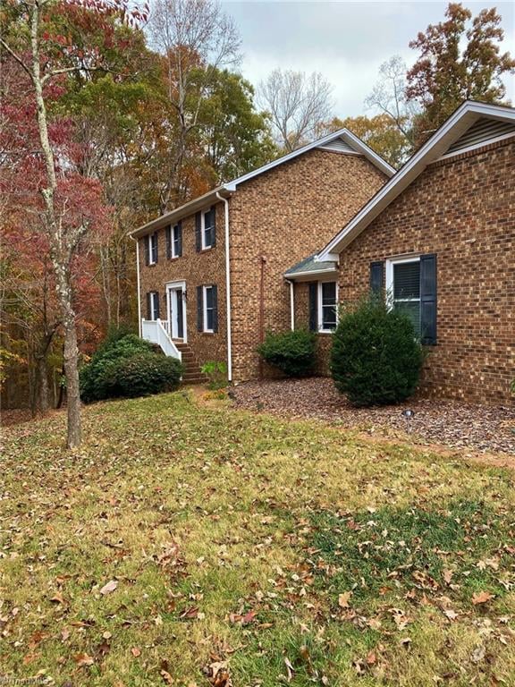 view of property exterior with a yard