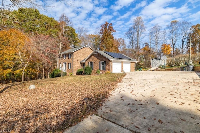 view of front of property featuring a garage and solar panels