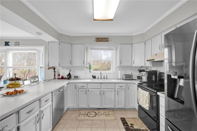 kitchen with white cabinets, light tile patterned flooring, crown molding, and appliances with stainless steel finishes