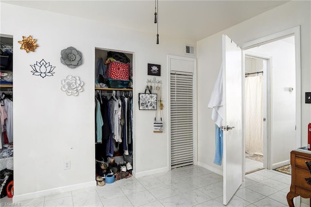 bedroom featuring baseboards, visible vents, and marble finish floor