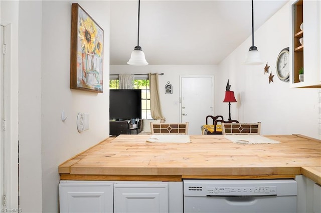 kitchen with hanging light fixtures, white cabinetry, butcher block counters, and dishwasher