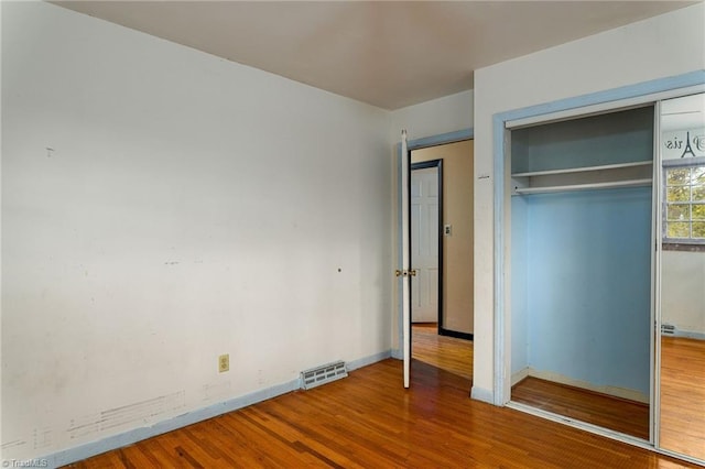 1526 Ann Arbor Ct, High Point, NC 27265 - unfurnished bedroom featuring wood finished floors, baseboards, and a closet
