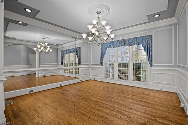 5005 Marble Arch Rd, Winston-Salem, NC 27104 - unfurnished dining area with a decorative wall, a chandelier, crown molding, wood finished floors, and recessed lighting