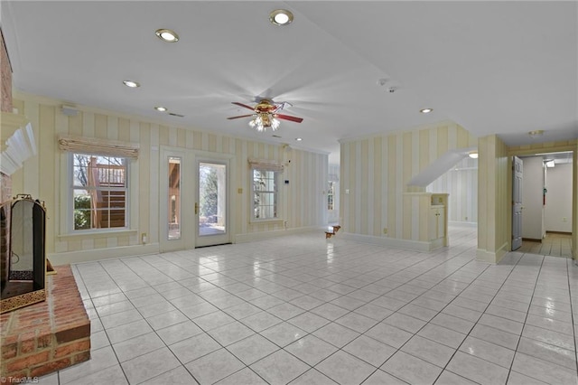 5005 Marble Arch Rd, Winston-Salem, NC 27104 - unfurnished living room with light tile patterned floors, ornamental molding, a fireplace, wallpapered walls, and a ceiling fan