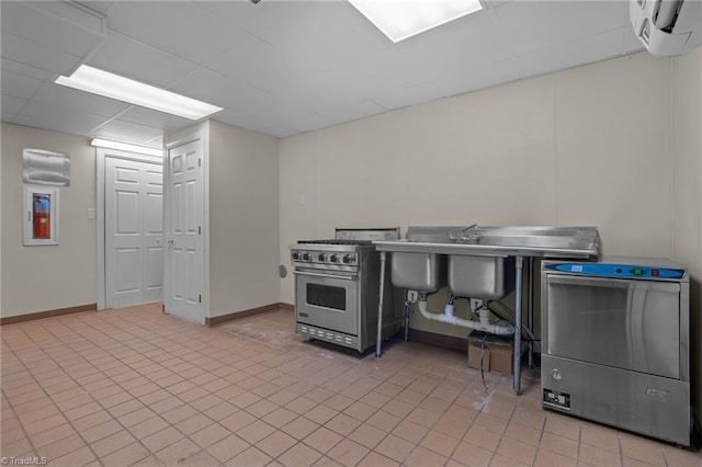 5005 Marble Arch Rd, Winston-Salem, NC 27104 - kitchen featuring high end stainless steel range, a wall mounted air conditioner, baseboards, and light tile patterned floors