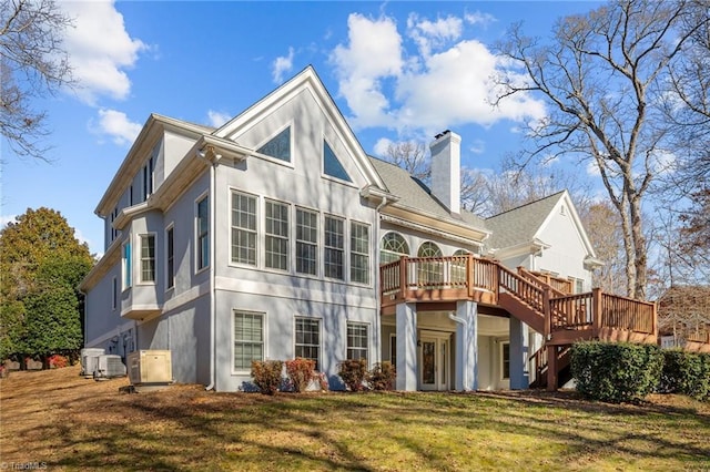 5005 Marble Arch Rd, Winston-Salem, NC 27104 - rear view of house with stucco siding, a wooden deck, a chimney, and a yard