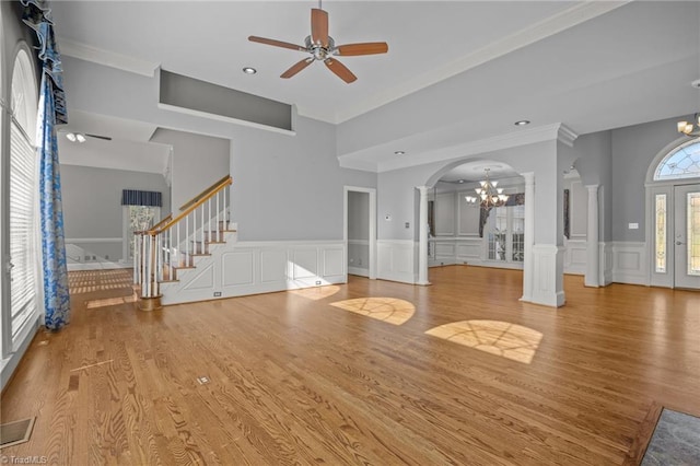 5005 Marble Arch Rd, Winston-Salem, NC 27104 - unfurnished living room featuring a chandelier, a ceiling fan, a decorative wall, stairway, and decorative columns