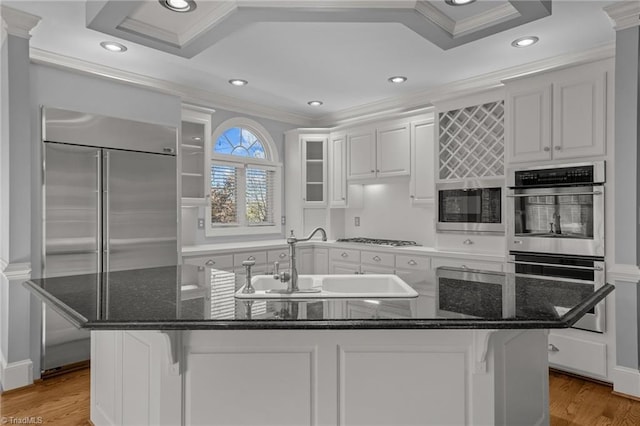 5005 Marble Arch Rd, Winston-Salem, NC 27104 - kitchen with built in appliances, a sink, crown molding, light wood finished floors, and white cabinetry