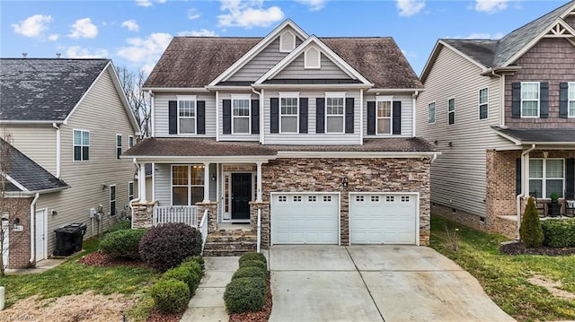 craftsman inspired home with a garage, a porch, and a front yard