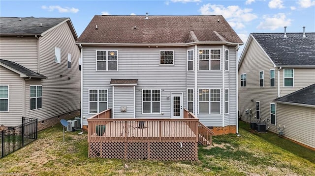 rear view of property featuring a wooden deck, a yard, and central AC