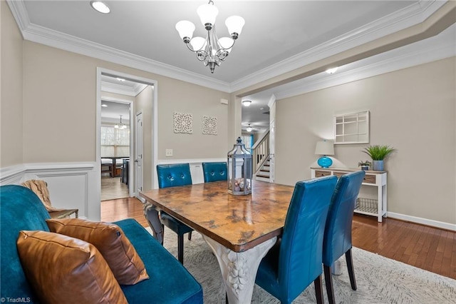 dining room featuring an inviting chandelier, ornamental molding, and hardwood / wood-style floors