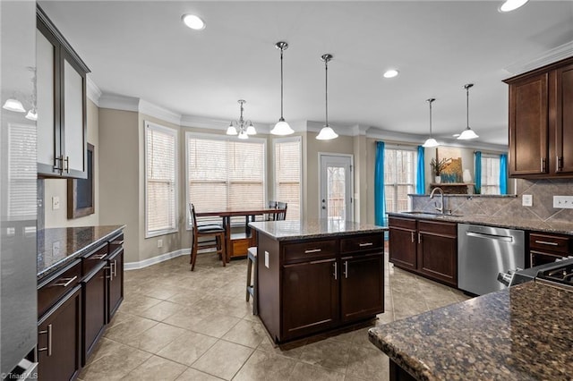 kitchen featuring stainless steel dishwasher, ornamental molding, a center island, and hanging light fixtures