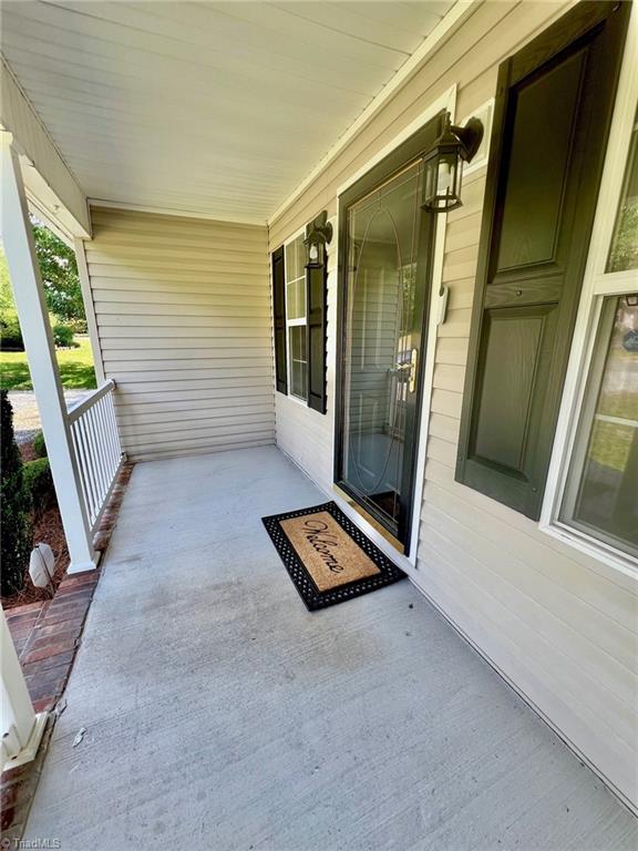 view of exterior entry featuring a porch