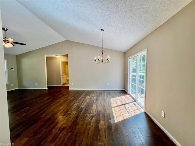 unfurnished dining area featuring dark wood-style floors, vaulted ceiling, a chandelier, baseboards, and ceiling fan