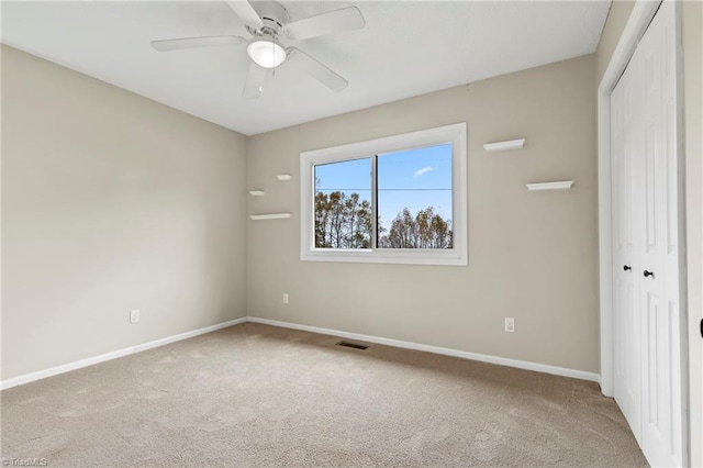 unfurnished bedroom featuring a closet, carpet flooring, and ceiling fan