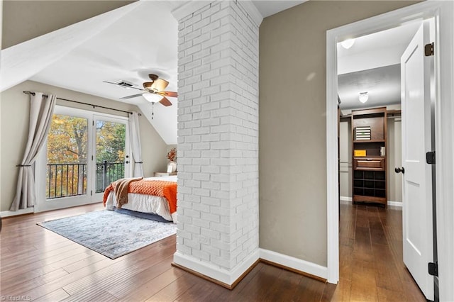 bedroom featuring hardwood / wood-style flooring, ceiling fan, access to exterior, and decorative columns