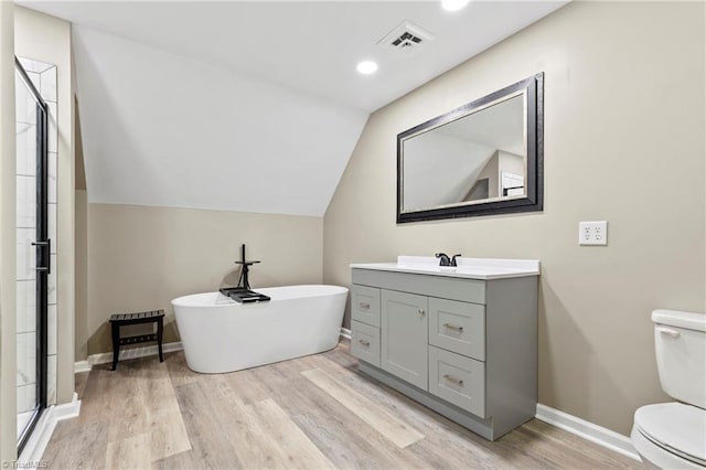 full bathroom featuring shower with separate bathtub, wood-type flooring, toilet, lofted ceiling, and vanity