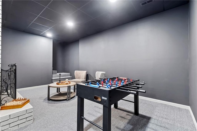 game room with a paneled ceiling and carpet floors