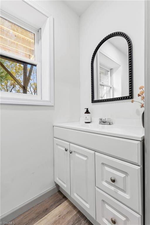 bathroom with vanity and hardwood / wood-style flooring