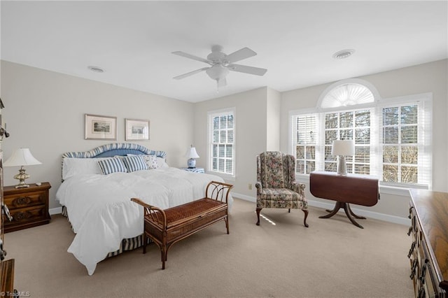 bedroom featuring light carpet, ceiling fan, visible vents, and baseboards