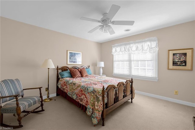 bedroom with baseboards, a ceiling fan, visible vents, and light colored carpet