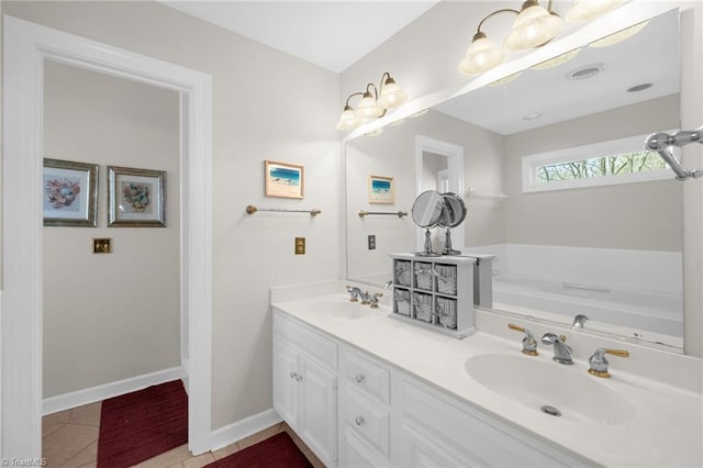 full bathroom featuring tile patterned flooring, a sink, baseboards, and a bath