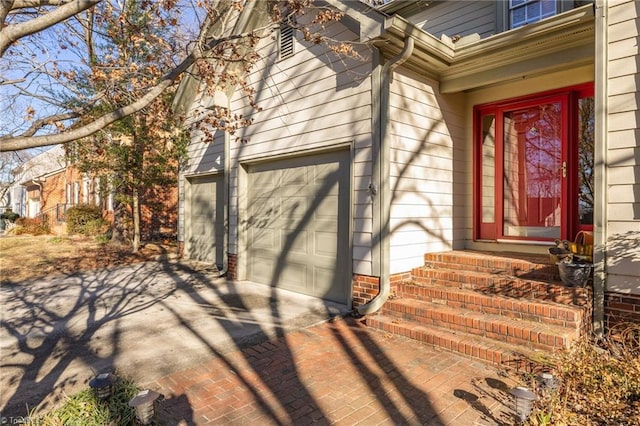 doorway to property with decorative driveway