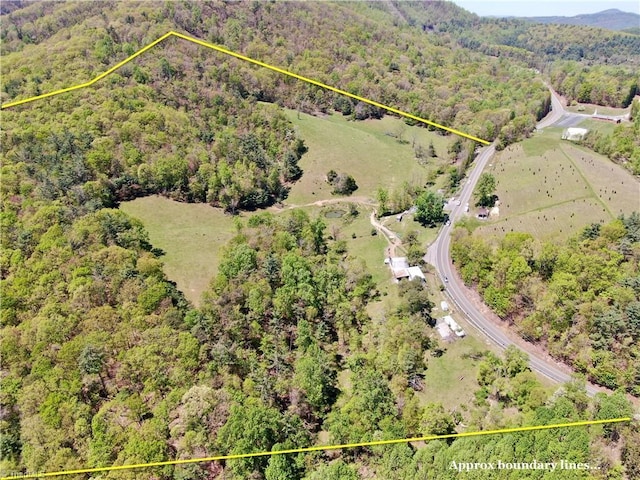 birds eye view of property with a view of trees