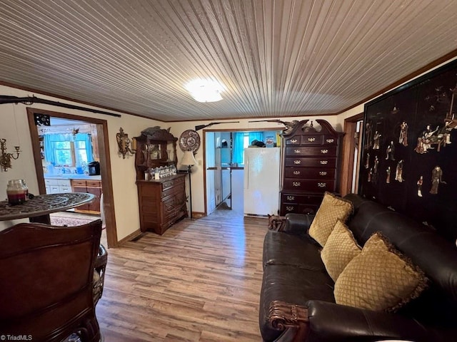 living area with wood finished floors and wooden ceiling
