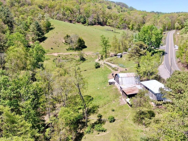drone / aerial view featuring a forest view